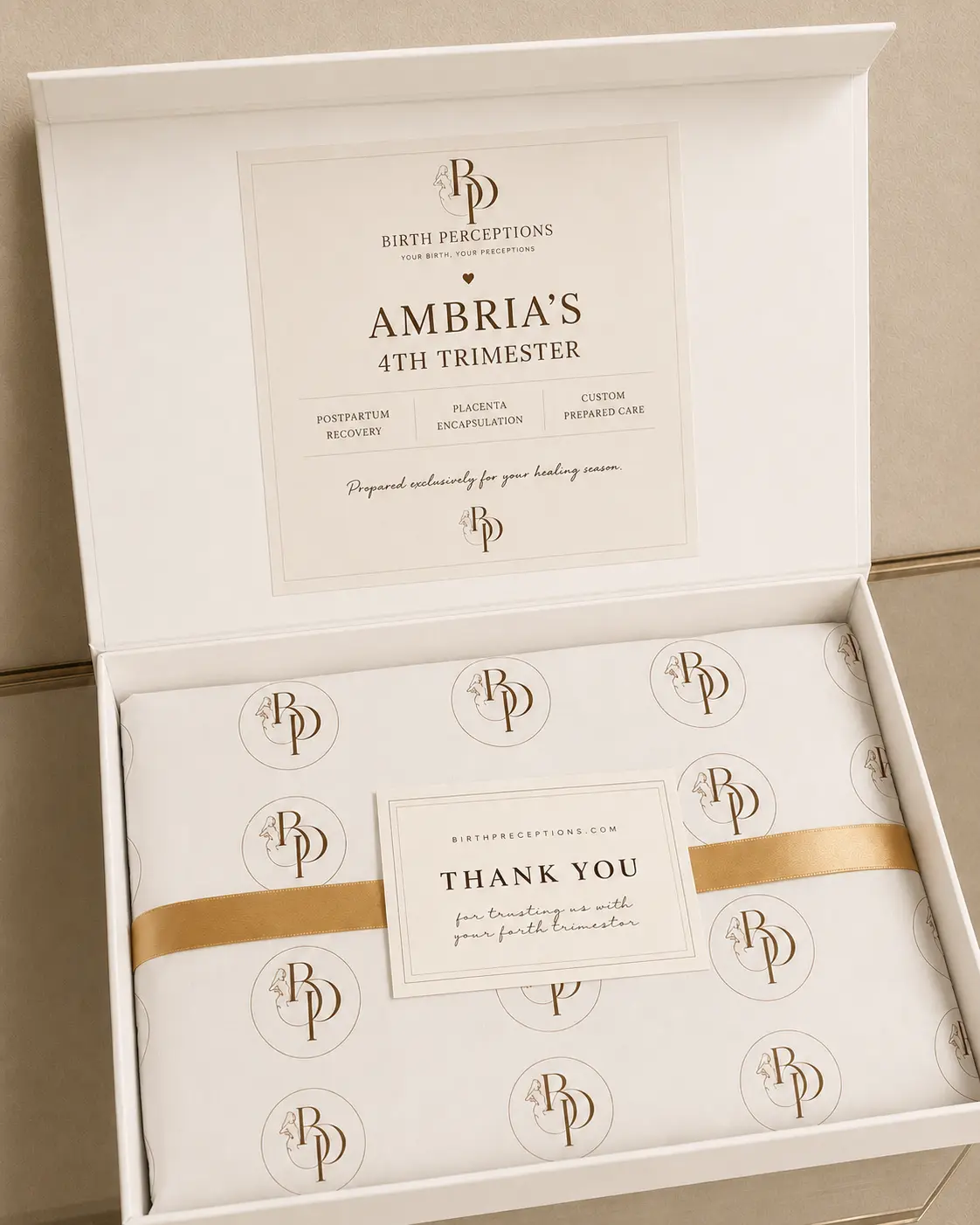 Ambria personalized Birth Perceptions keepsake box wrapped with branded tissue and ribbon