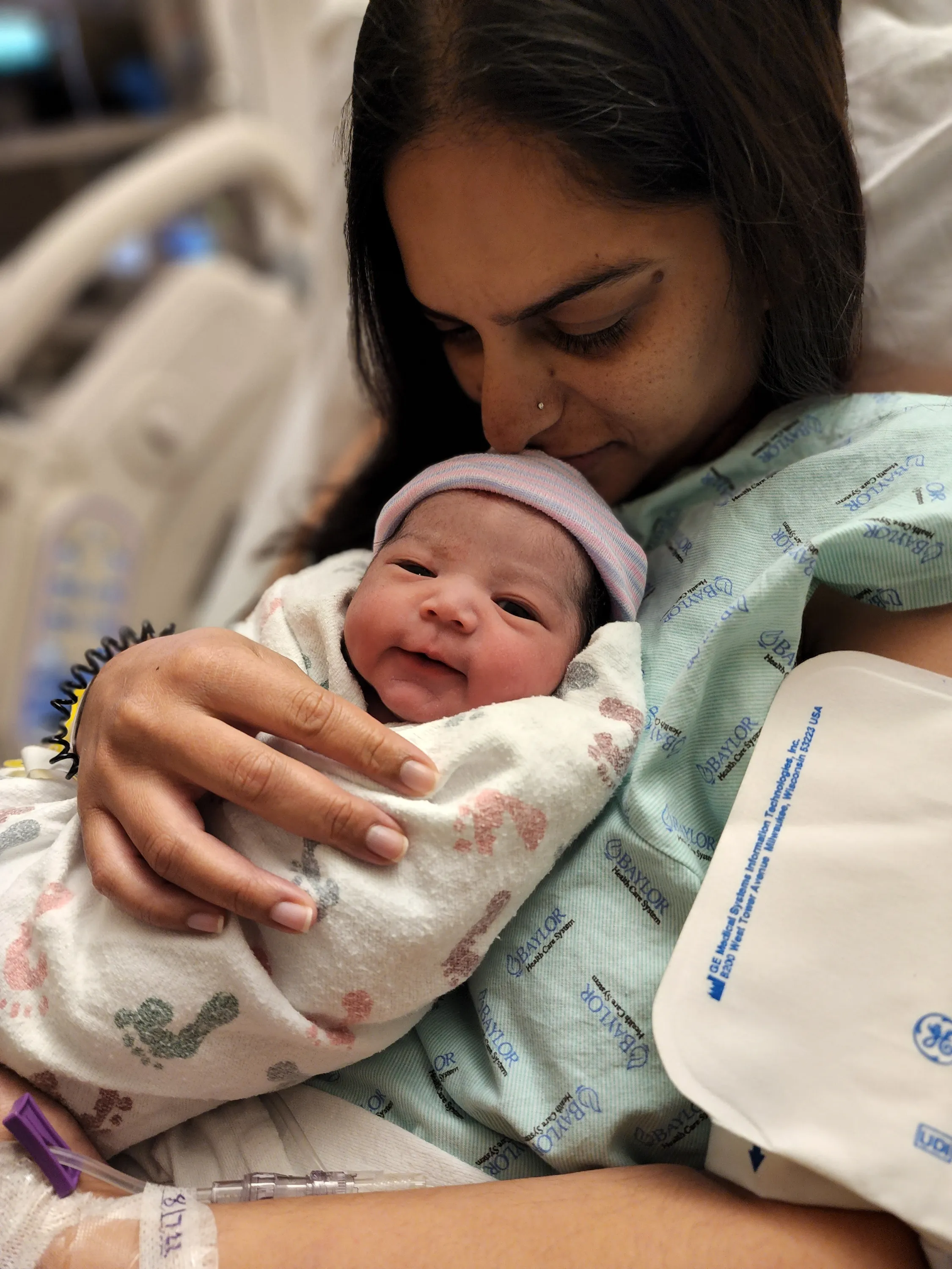 Mother kissing newborn