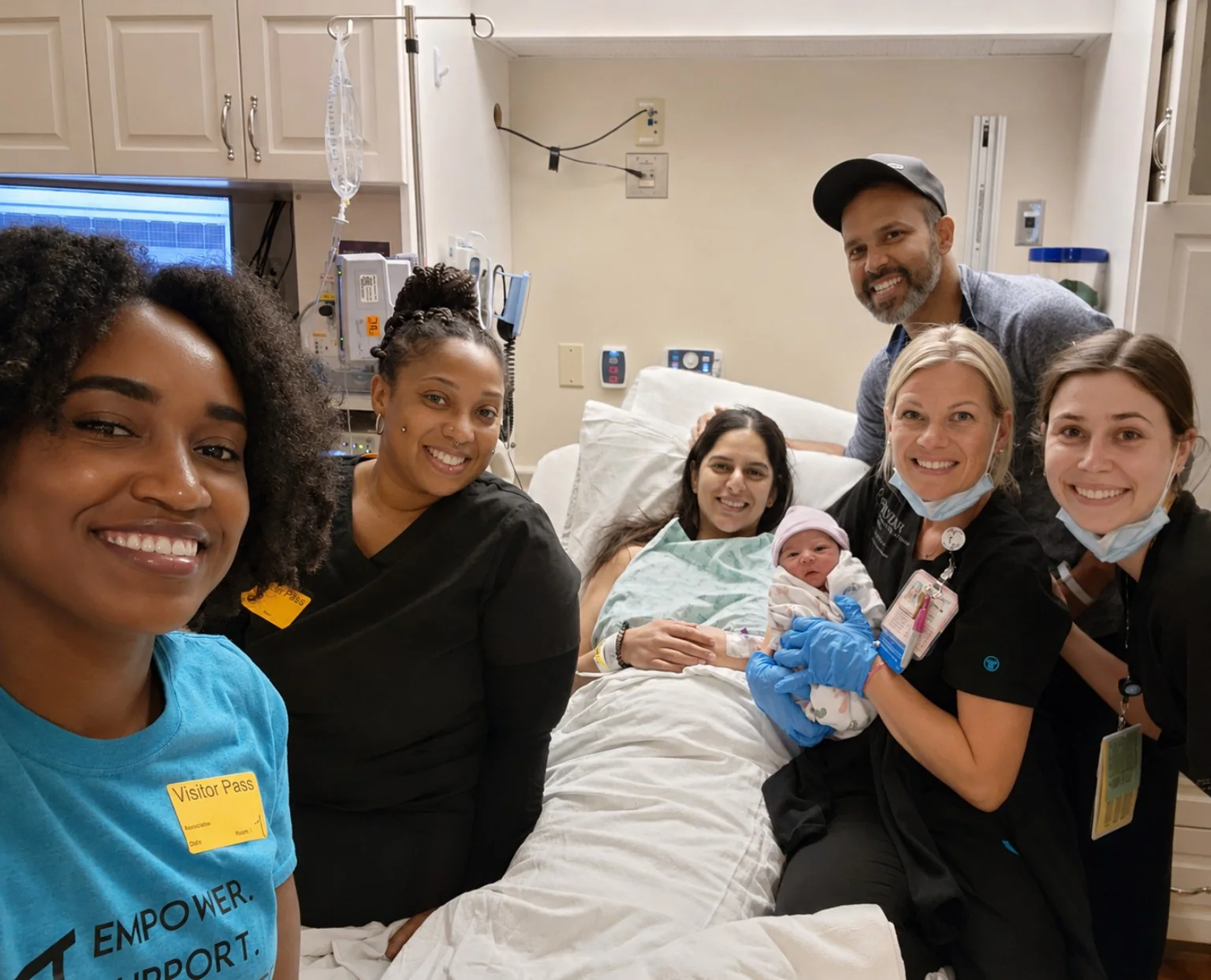 Mother, newborn, family, and hospital birth team together