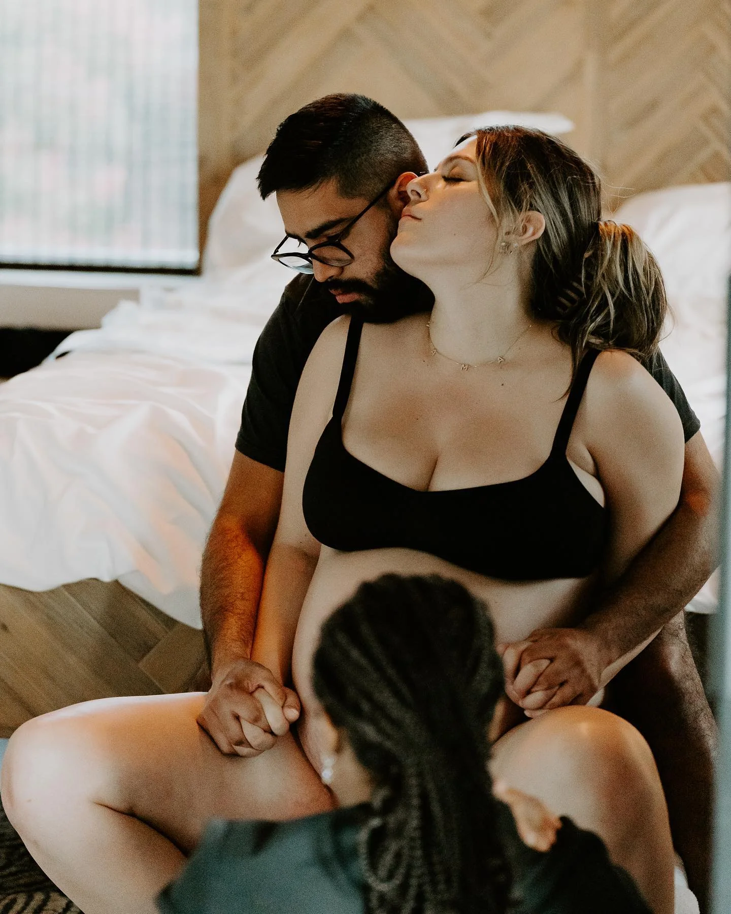 Partner and doula supporting a mother during labor