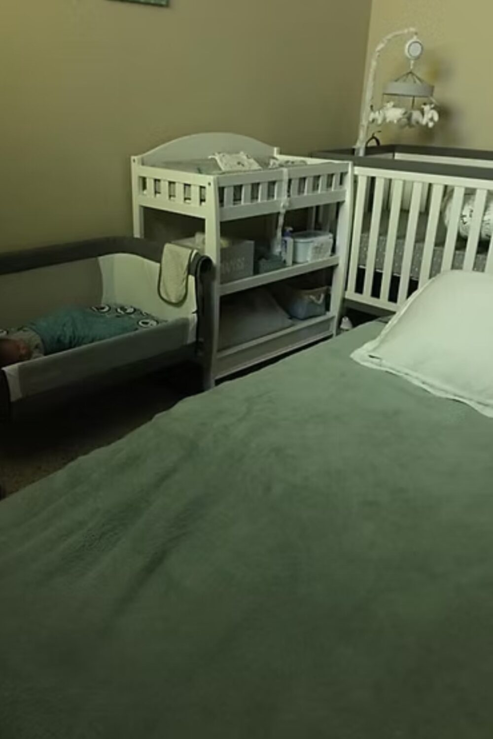 Mother kissing her swaddled newborn in the first hours after birth