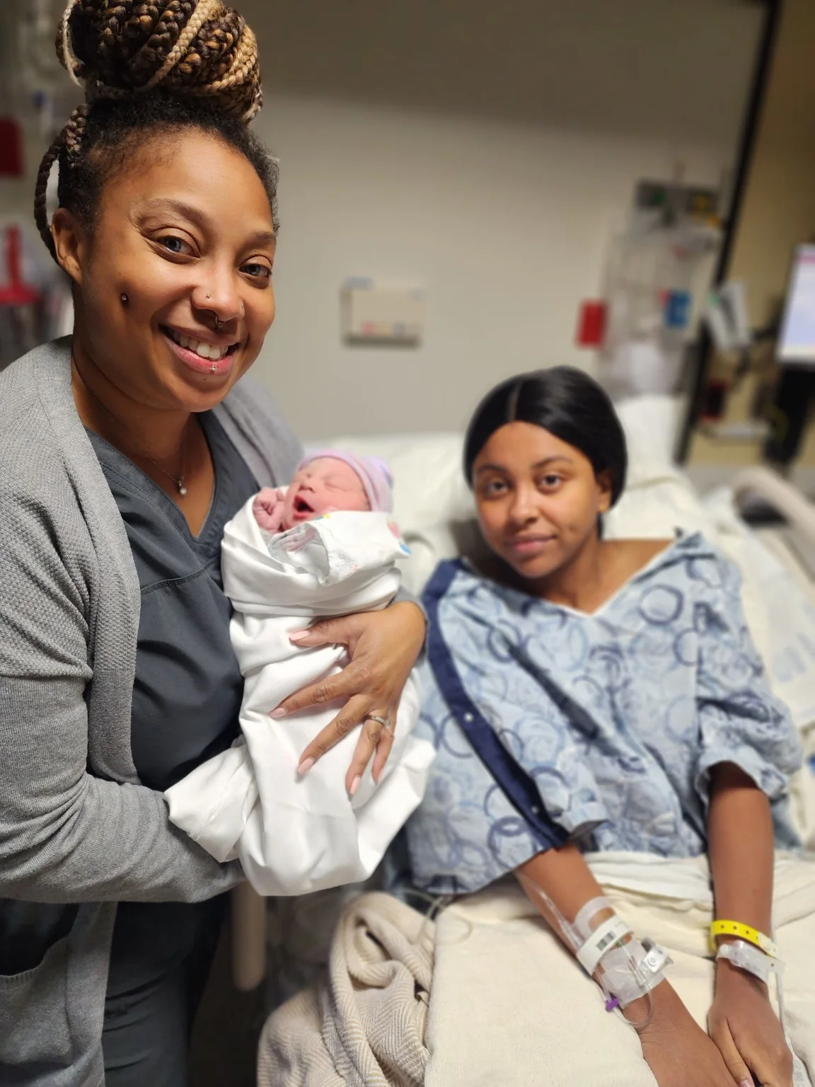 Birth Perceptions holding a newborn beside the mother