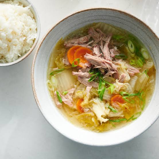 White kimchi soup with rice and chicken-style clear broth