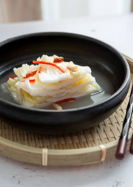 White kimchi in a mild clear brine